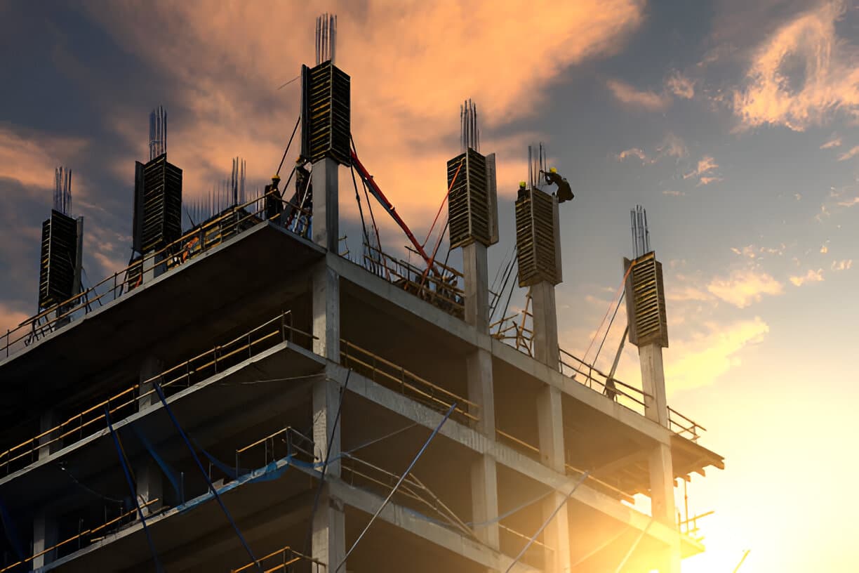 Construction site with building under construction at sunset